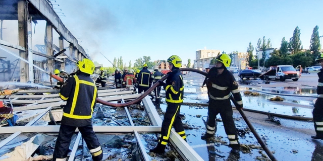 Rescue teams are working at the scene of a shopping mall hit by a Russian missile strike in Kremenchuk, Ukraine, on Monday, June 27.