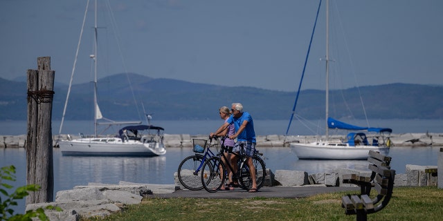 Cyclists are shown at Lake Champlain in Burlington, Vermont, on June 29, 2021.