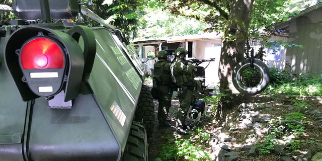 A SWAT team arrives at the home of a man who reportedly threatened to bomb a grade school.