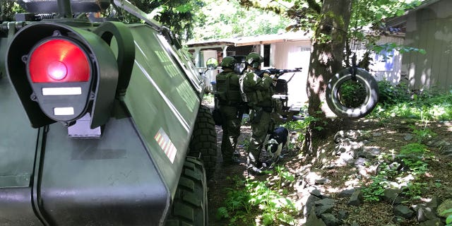 A SWAT team arrives at the home of a man who reportedly threatened to bomb a grade school.