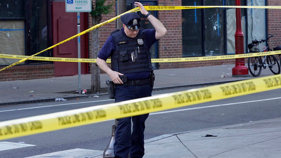 Philadelphia officer and crime scene tape after mass shooting