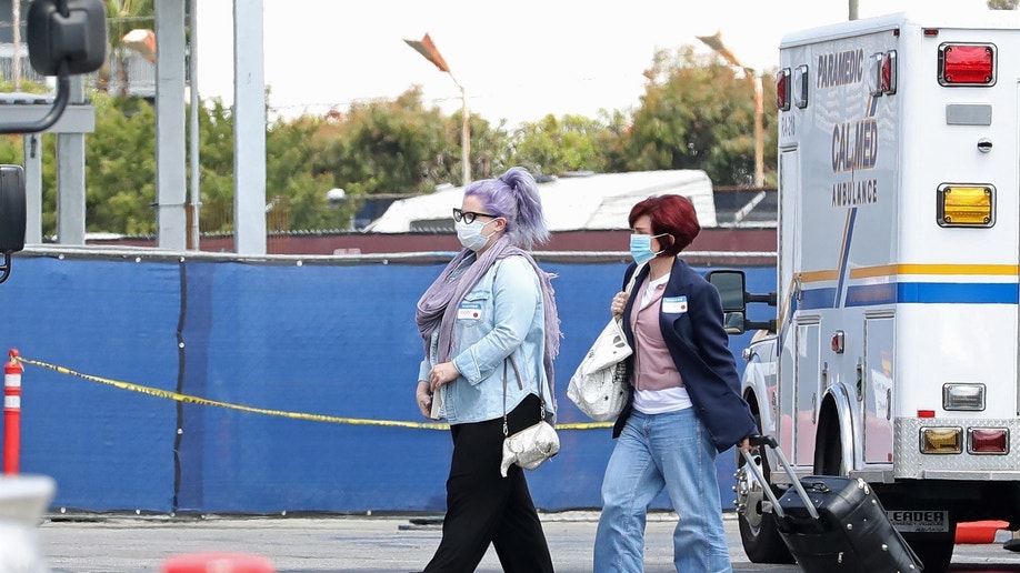Sharon Osbourne, Kelly Osbourne with luggage walking