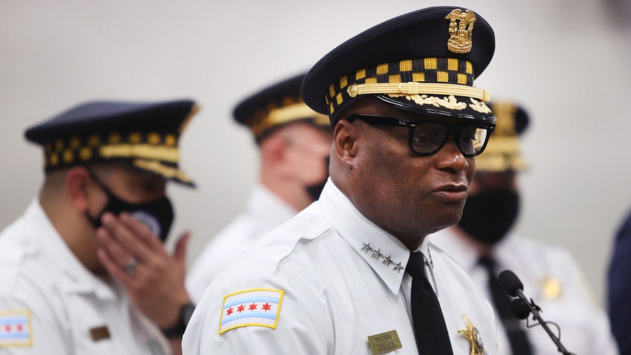 Chicago David Brown delivers remarks in a white uniform and a black hat