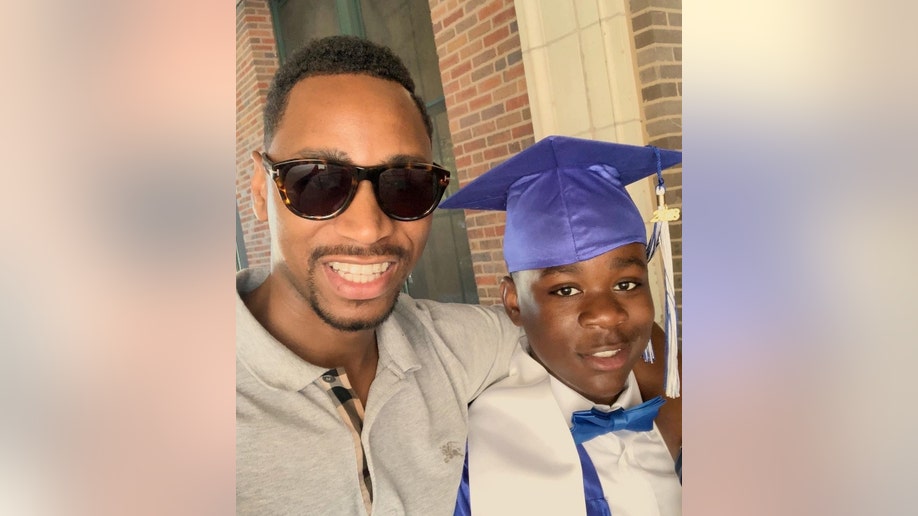 Gianno Caldwell and his younger brother Christian wearing a blue mortarboard