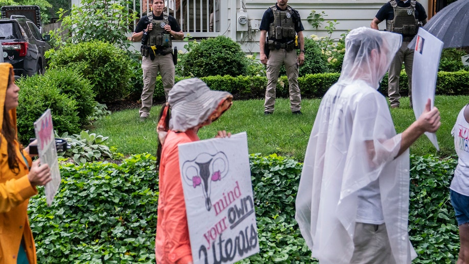 Protesters march past Supreme Court Justice Brett Kavanaugh's home