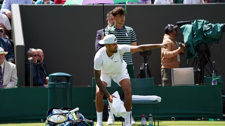 Nick Kyrgios points on court