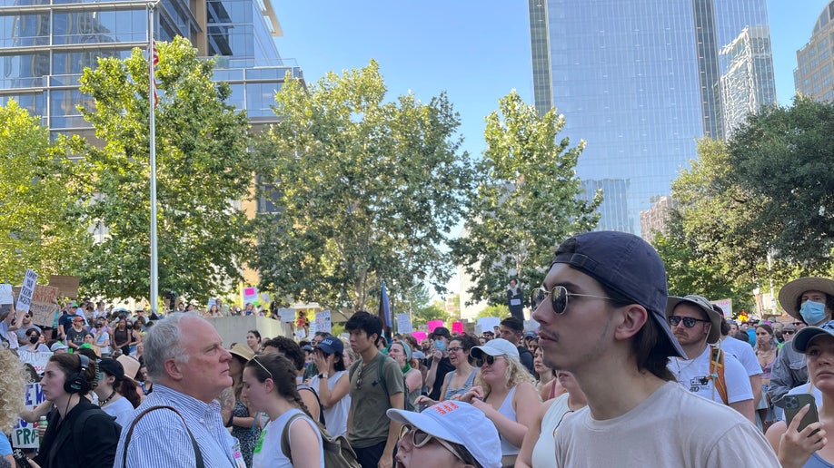 Activists stand holding pro-choice signs in Austin, Texas