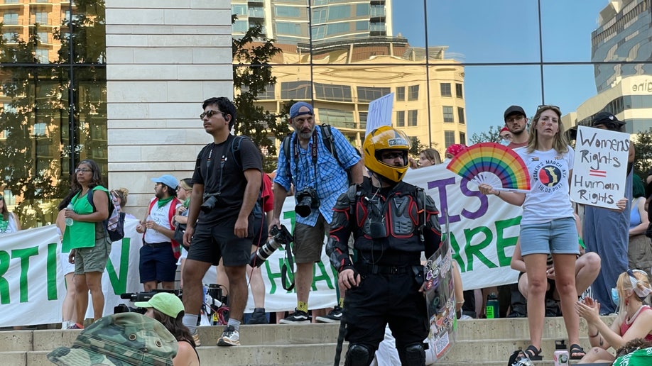 Activists sit and stand during a protest in Austin, Texas