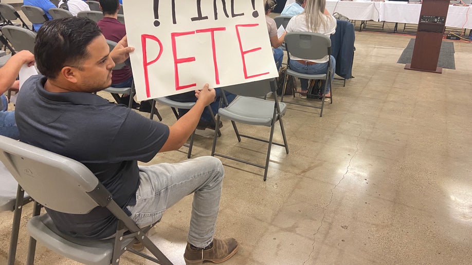 Uvalde man holds sign demand Arredondo fired