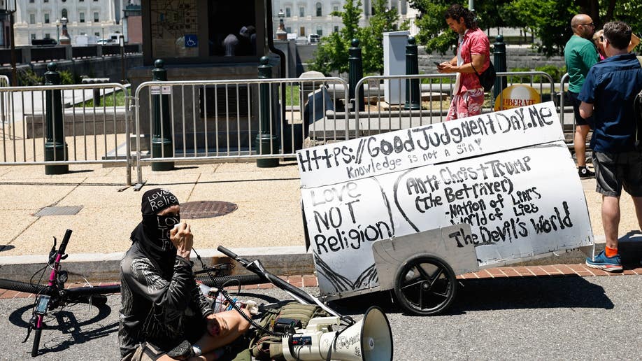 A man speaks into a megaphone