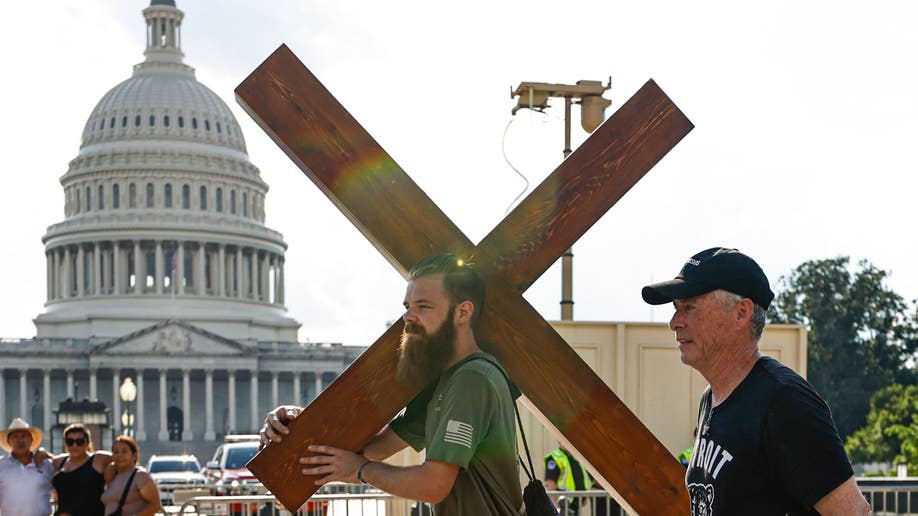 Man holds cross