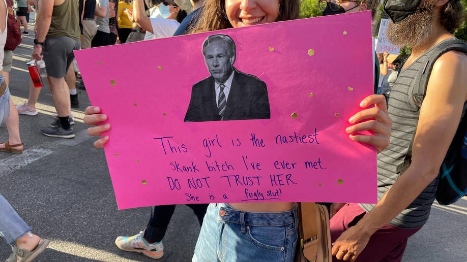 A woman holds a pro-choice sign