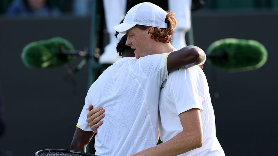 Jannik Sinner and Mikael Ymer embrace following their match