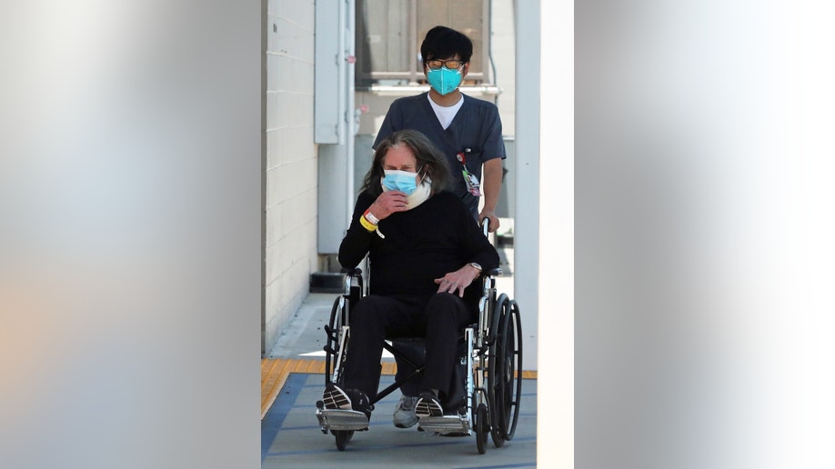 Ozzy Osbourne in a wheelchair following surgery