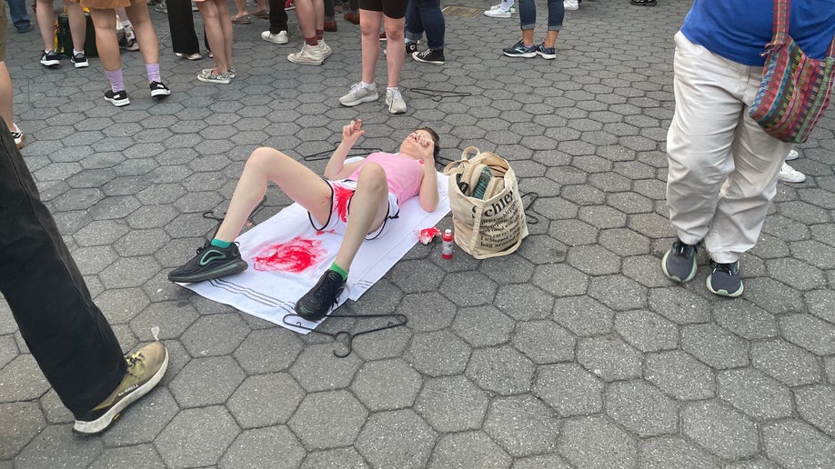 Protester With Fake Blood And Wire Hanger