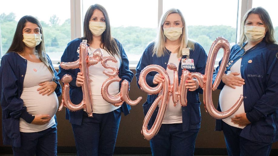 Pregnant nurses at Saint Luke's East Hospital hold 'It's a girl' balloons