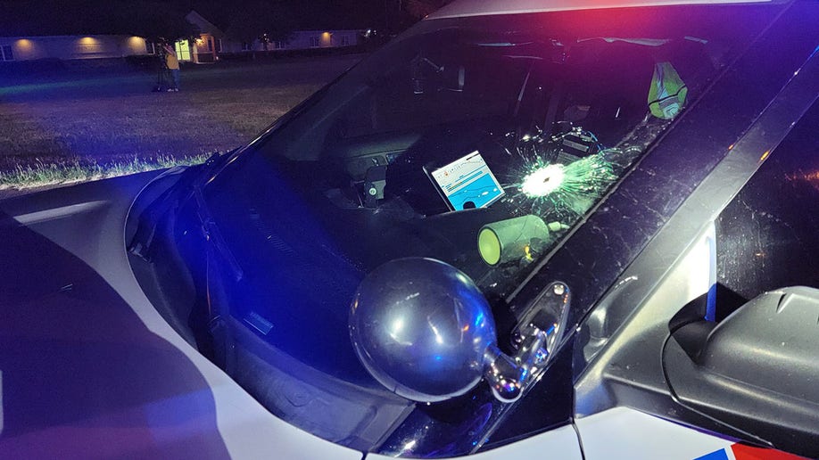 Police cruiser with bullet hole in windshield