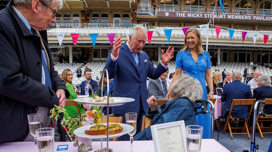 Prince Charles converses with guest