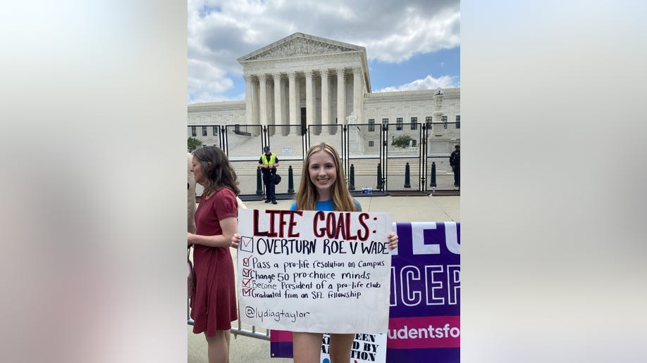 A woman holds a sign supporting the overturning of Roe vs. Wade