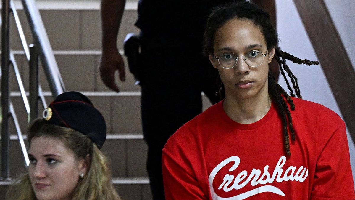WNBA star Brittney Griner arrives in court in Russia, wearing a red shirt