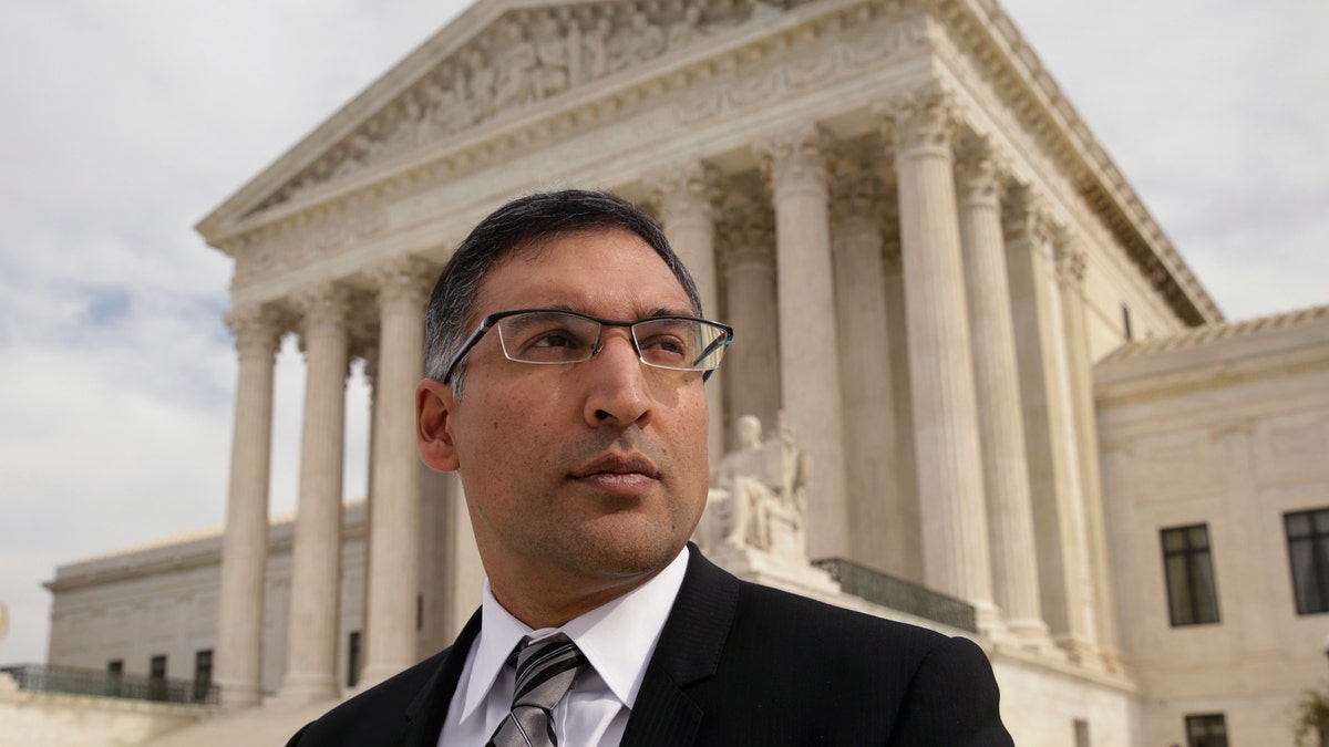 Neal Katyal gazes up on the steps of the U.S. Supreme Court in Washington DC