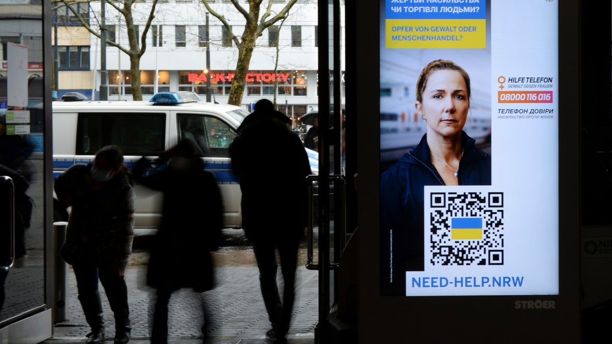 SIgns in Germany warn Ukrainian refugees about trafficking amid Russia's invasion