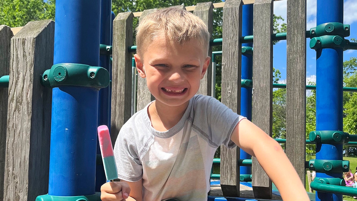 Highland Park mass shooting victim Cooper Roberts, 8, smiles at the playground holding a popsickle