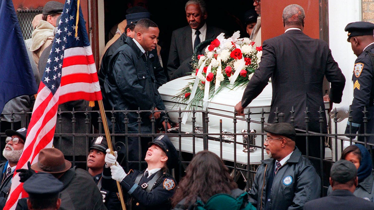 Pallbearers carry the remains of token clerk Harry Kaufman