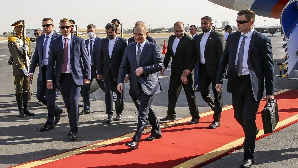 Putin and officials in sharp suits arrive at airport in Tehran, Iran