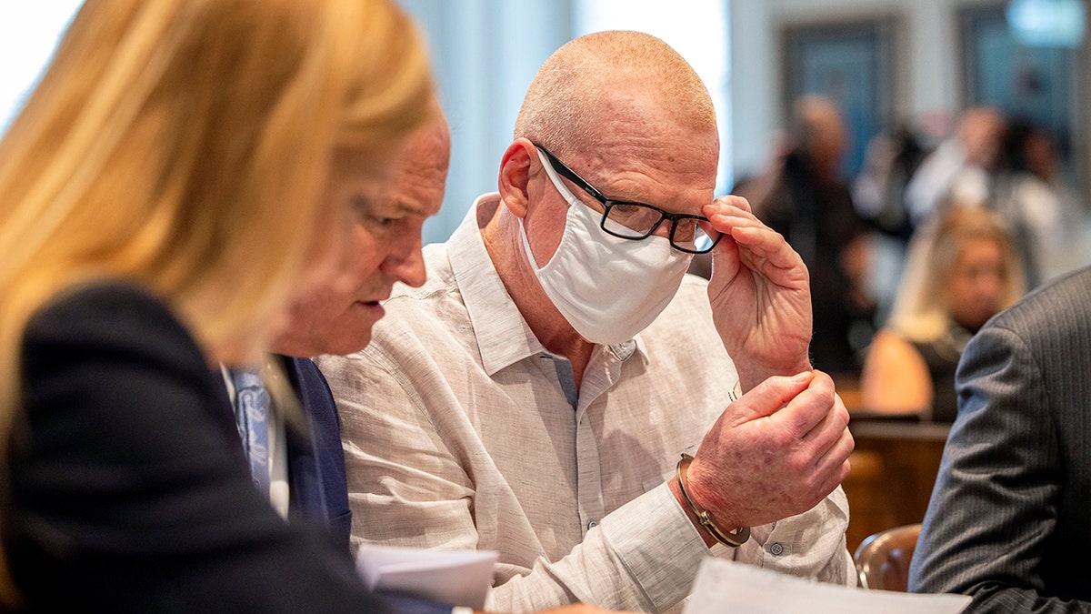 alex murdaugh fixes glasses at murder arraignment