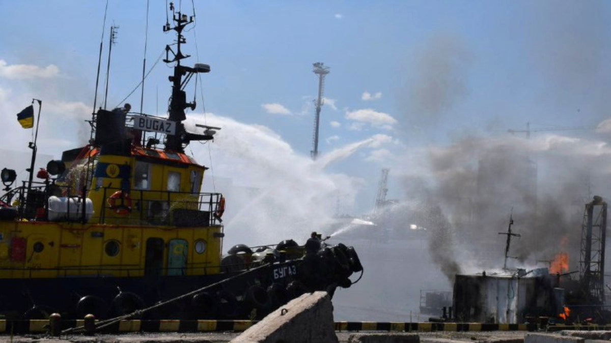 firefighters put out a fire in the port after a Russian missiles attack in Odesa