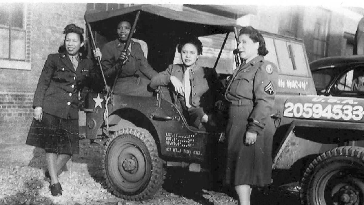 The 6888th Central Postal Directory Battalion stand near truck