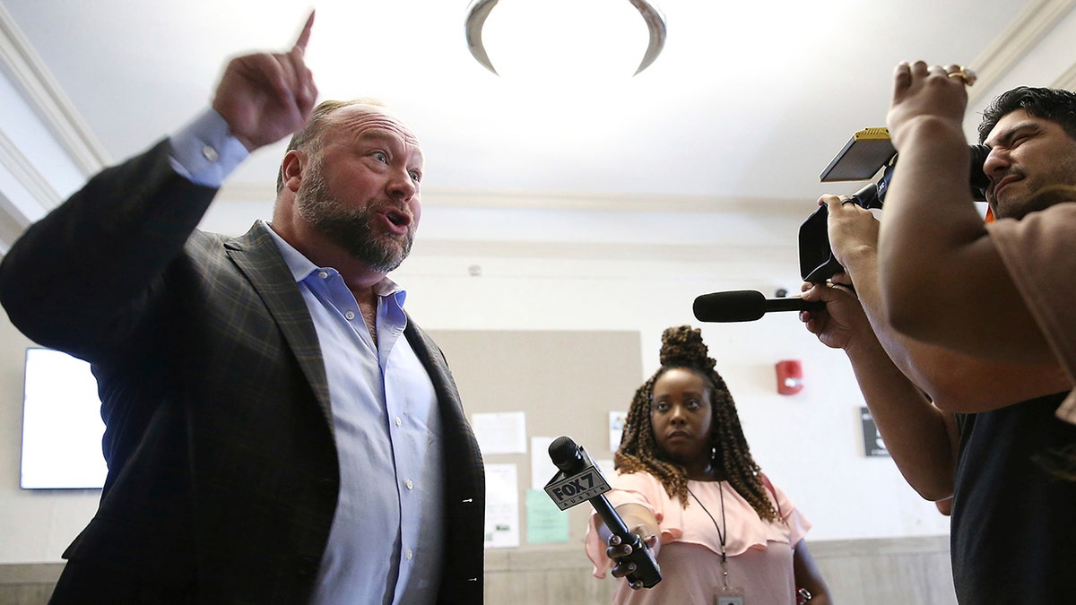 Infowars' Alex Jones speaks to reporters at Texas courthouse