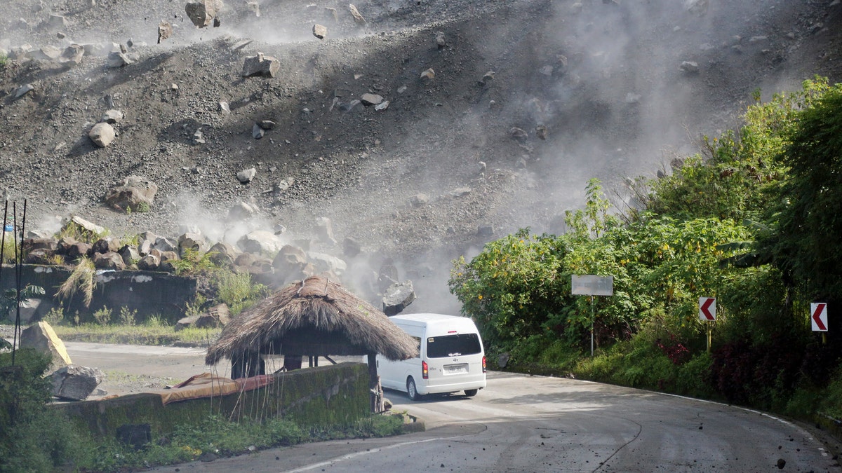 A car is hit by falling rocks during an earthquake in the Philippines