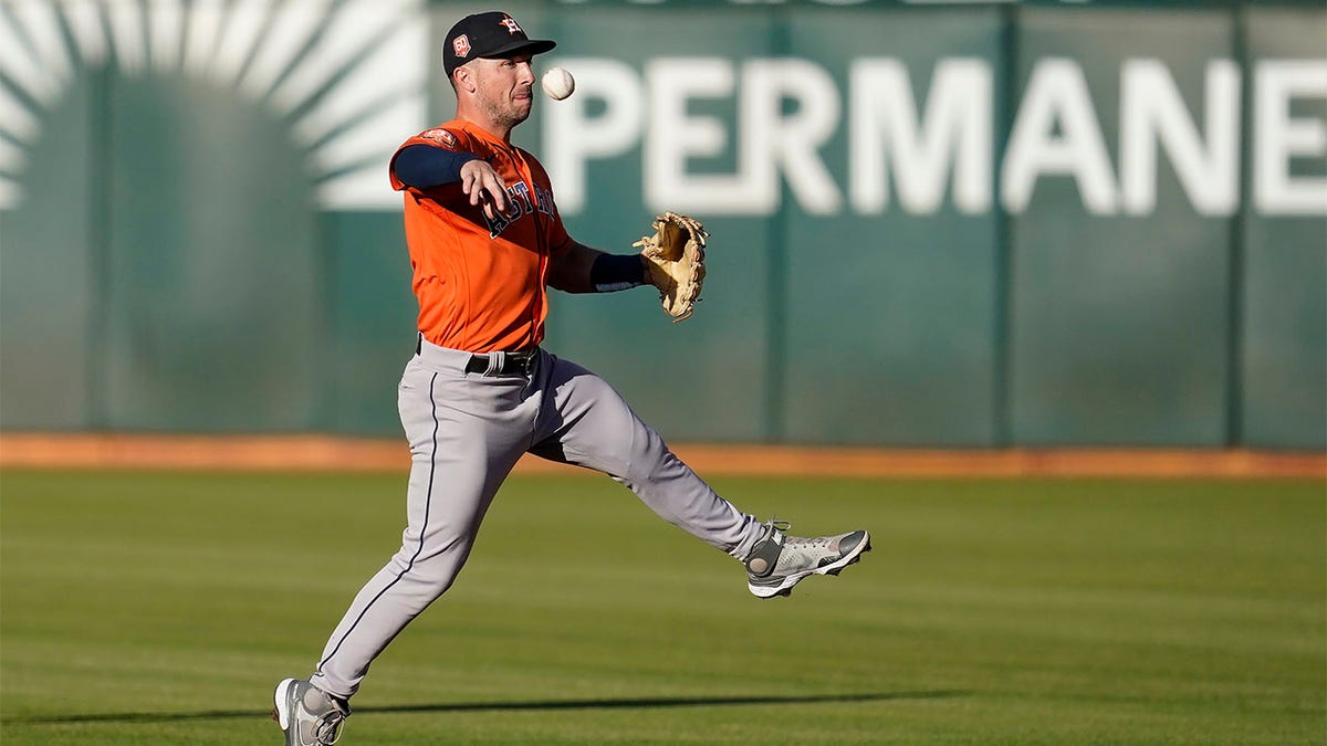 Alex Bregman throws ball to first base