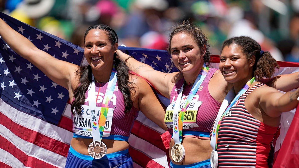 Brooke Anderson, Camryn Rogers, Janee' Kassanavoid celebrate with their medals