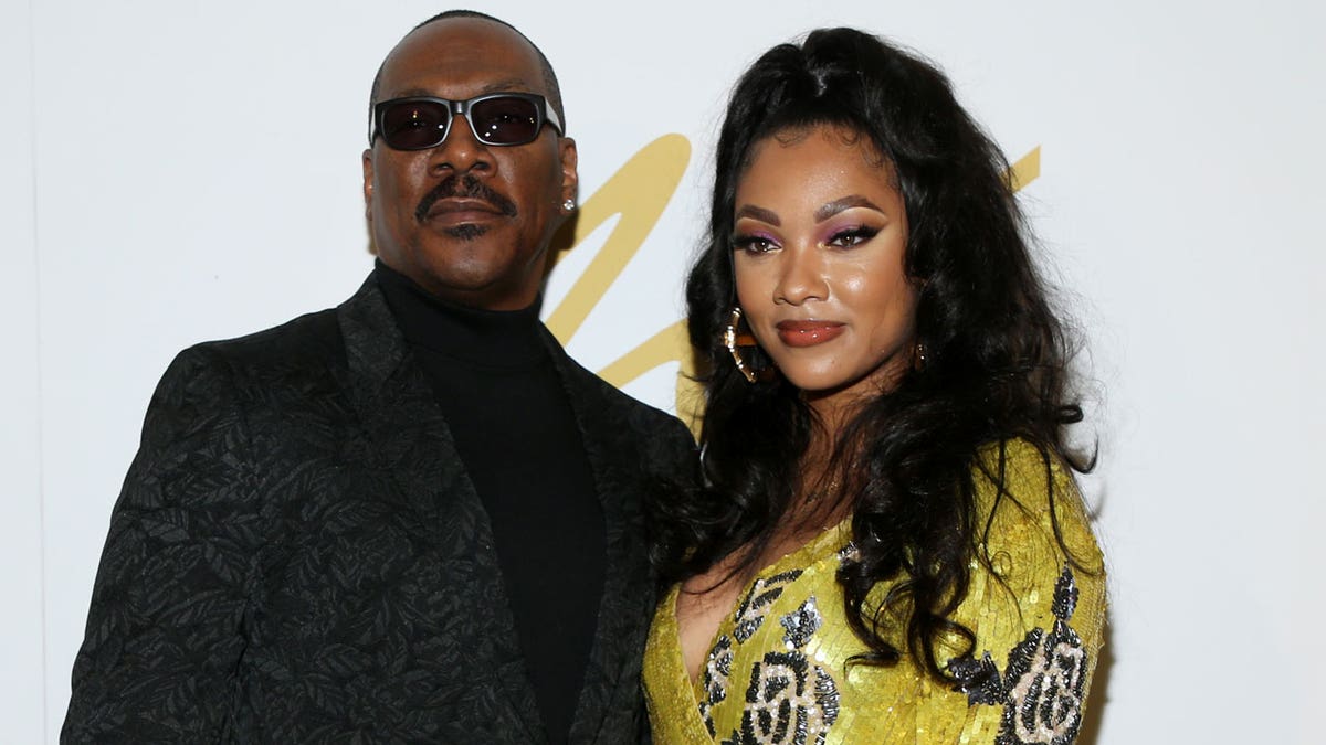 Eddie Murphy and his daughter pose for a photo 