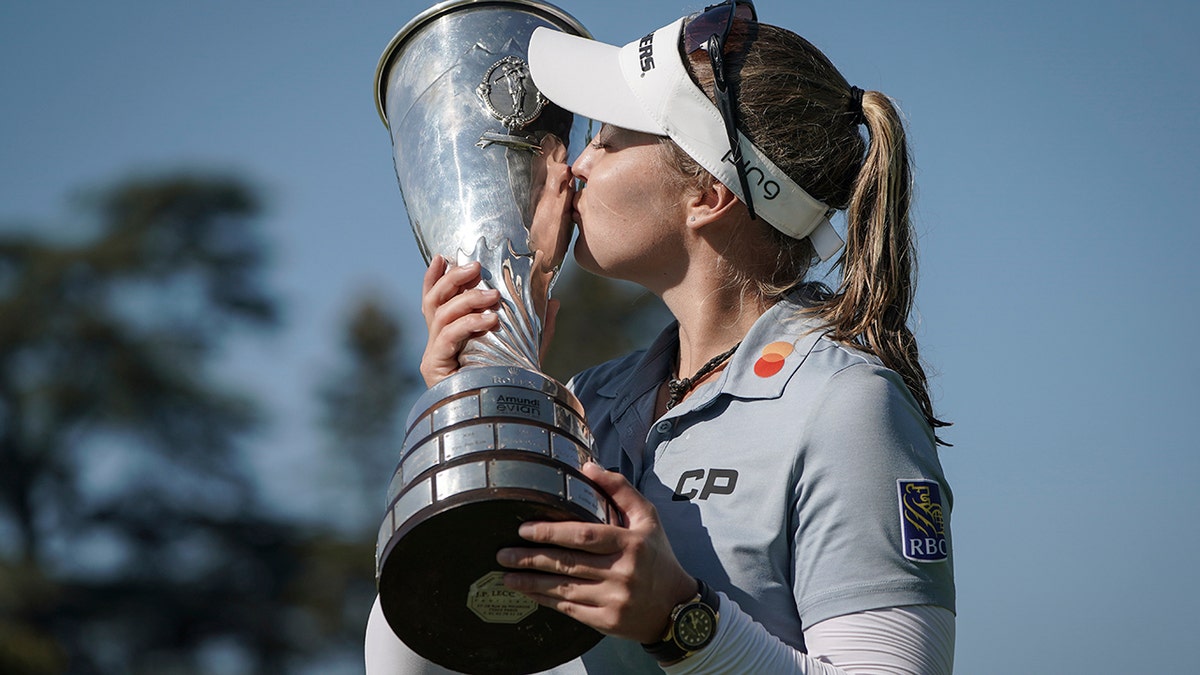 Brooke Henderson kisses the trophy