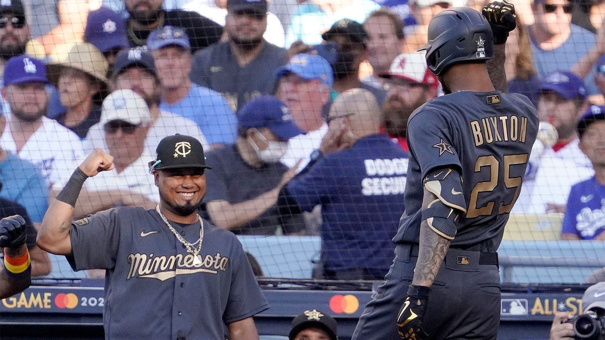 Byron Buxton celebrates with Luis Arraez