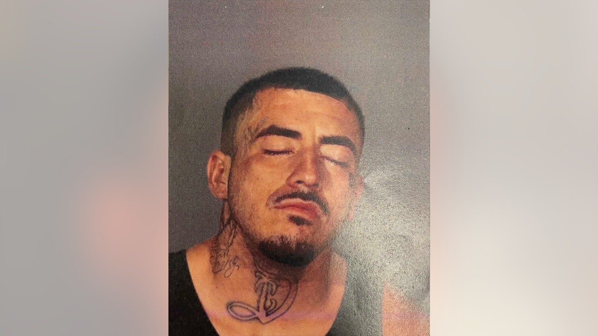 Andrew cachu has his eyes closed in this new mugshot