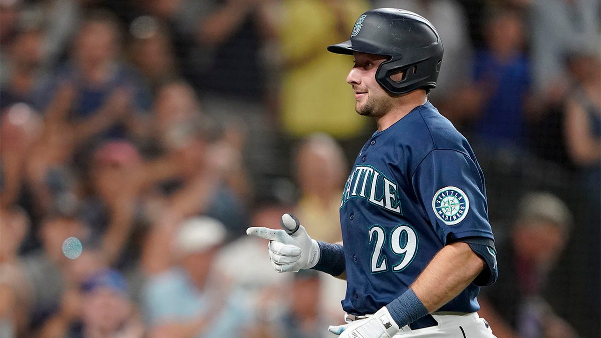 Cal Raleigh celebrates hitting home run