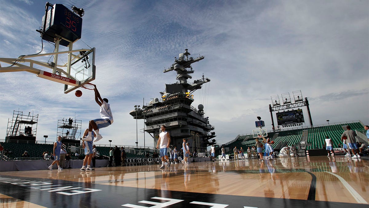 Players practice on carrier court