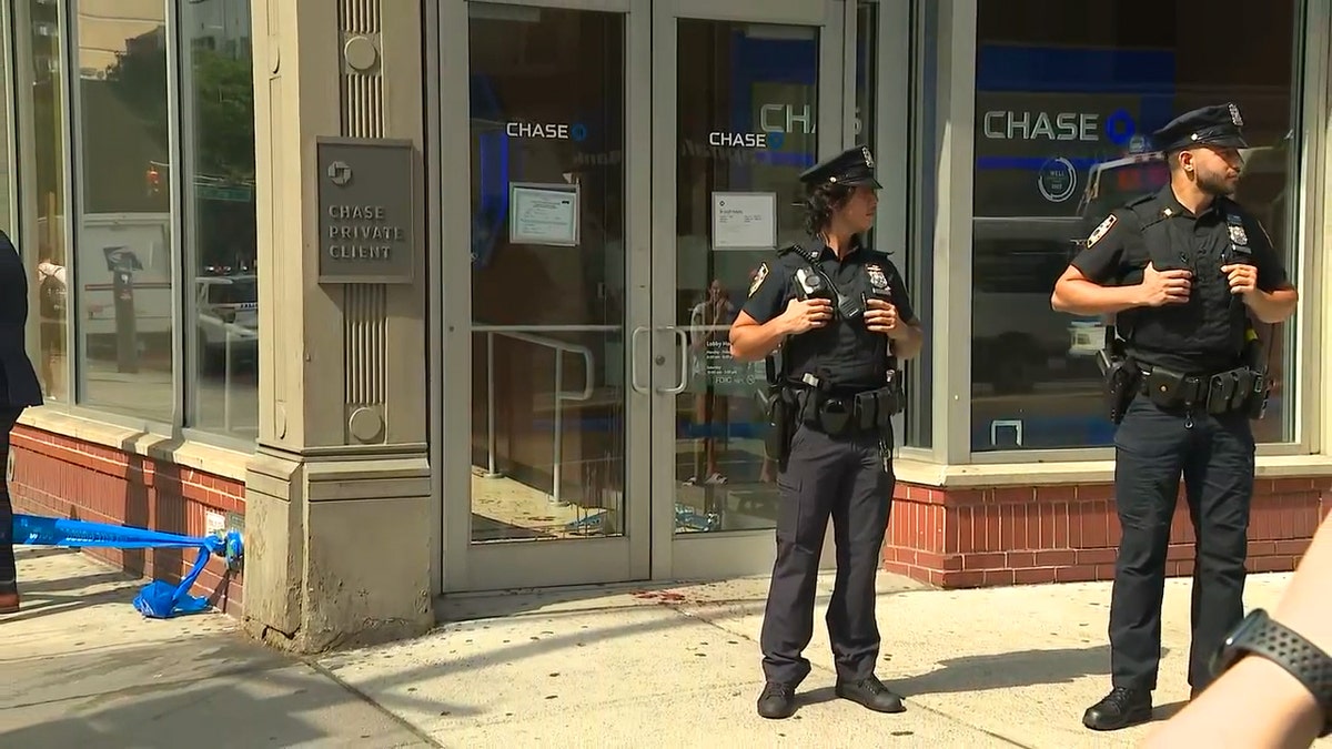 Two NYPD officers guarding the scene