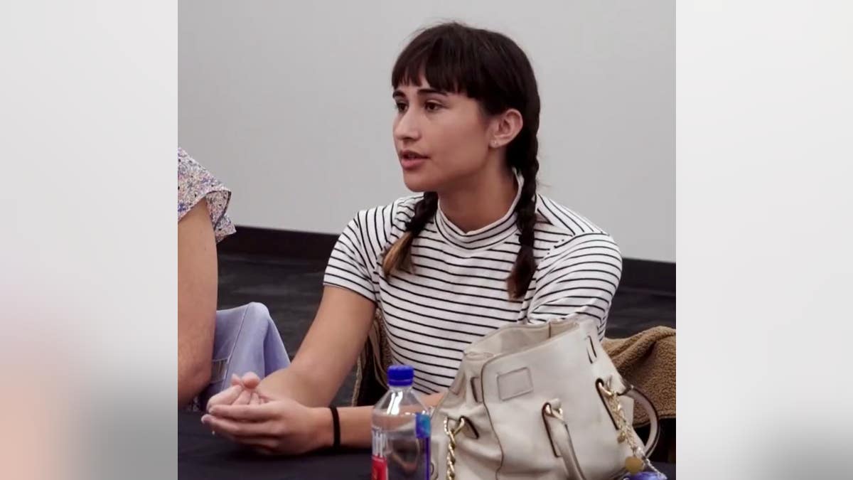 Chloe Cole with pigtails in a striped shirt