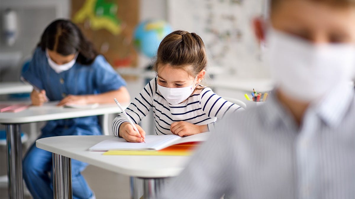 Child taking test in a mask