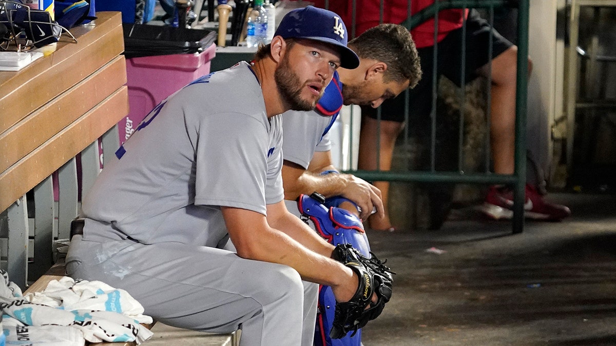 Clayton Kershaw sits in the dugout