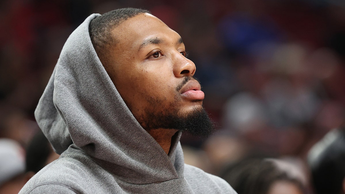 Damian Lillard watches a game in March 2022