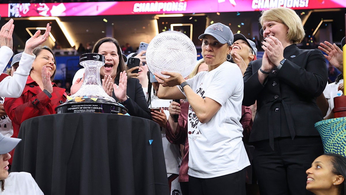 Dawn Staley holds the trophy