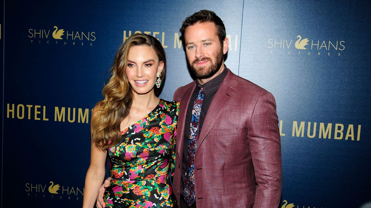 Elizabeth Chambers and Armie Hammer appear on the red carpet