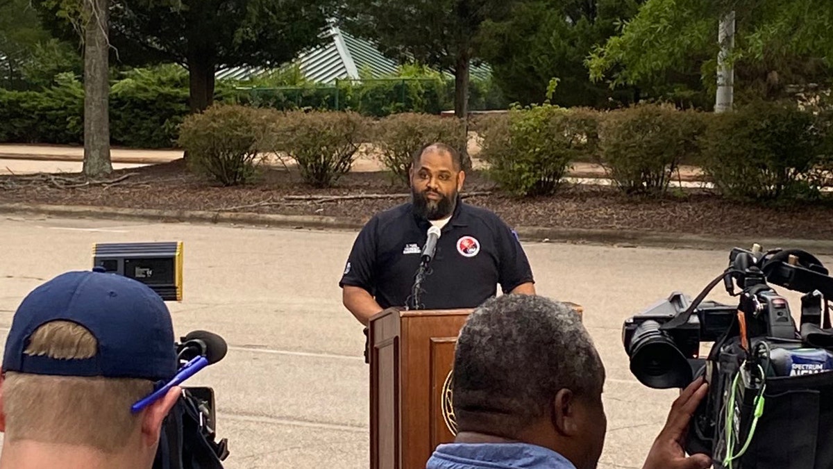 The emergency management chief speaking behind a podium